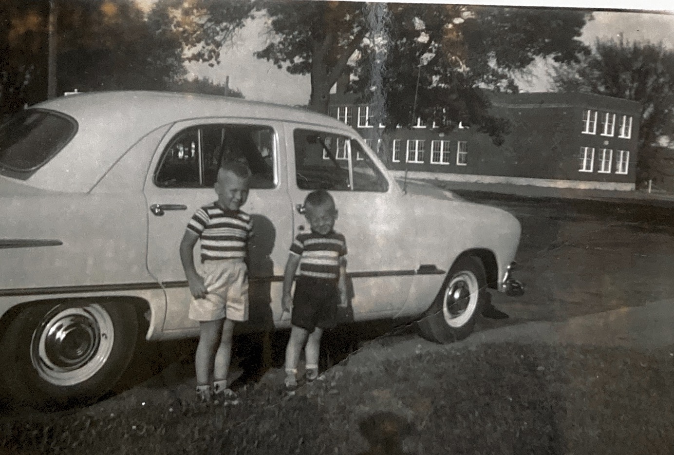 Me and my brother  In front of dad’s new car 1954.