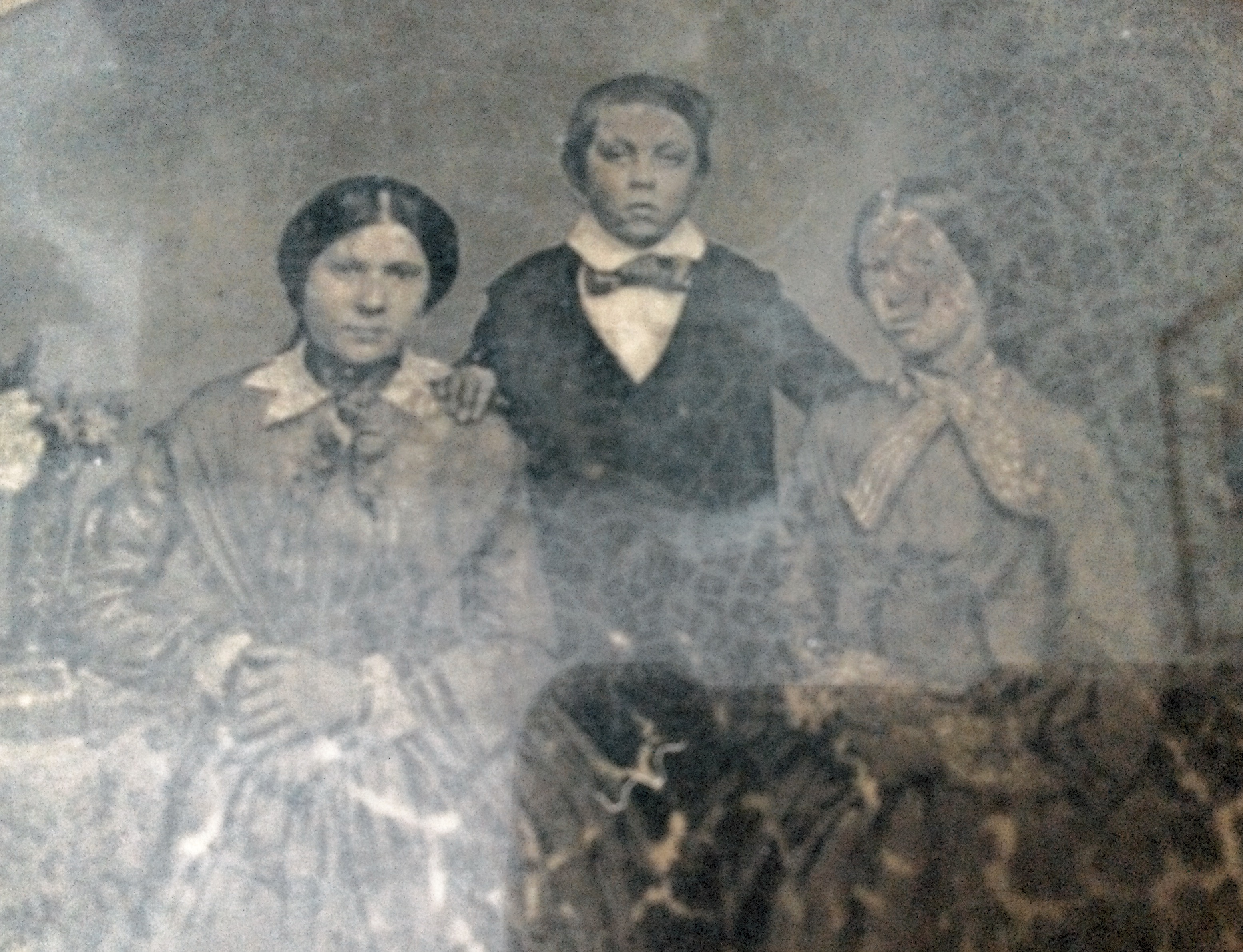 Charles Noyes (grandfather of Phyllis Eardley-Simpson, great grandfather of Susan Beech nee E-S) and his 2 sisters. On right, she died young. On left, married a parson, Withers, and had a daughter Ethel Withers (headmistress of Bury High School). Daguerreotype c1850-70. Some age damage.