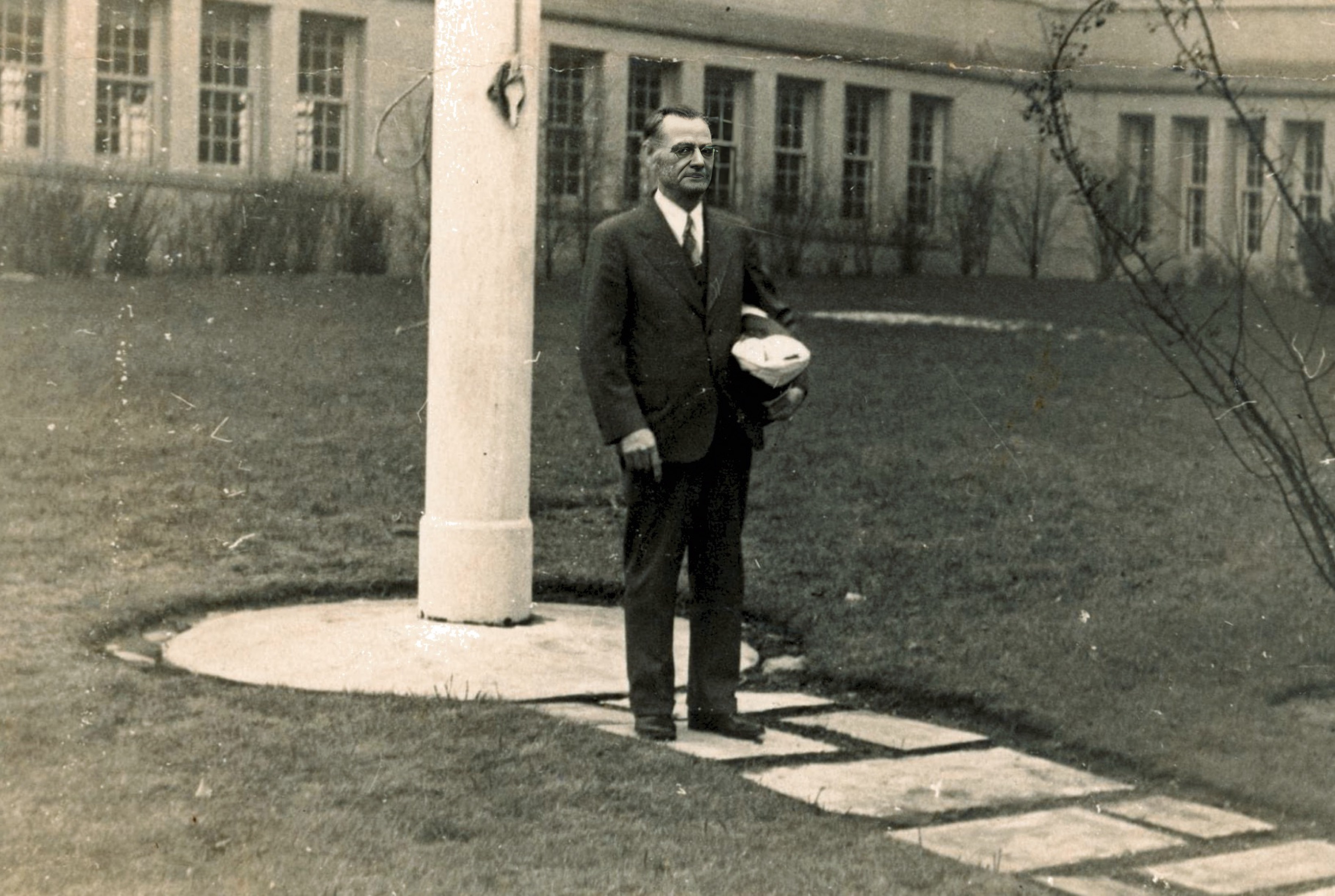 Charles T Mellen takes down flag at Bayside High School on the day of his retirement on 16 February 1941 at the age of 62