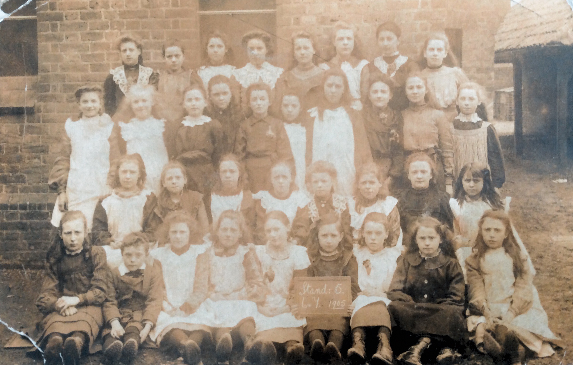School photo from 1905. Probably my grandmother Gertrude Manley holding the plaque.