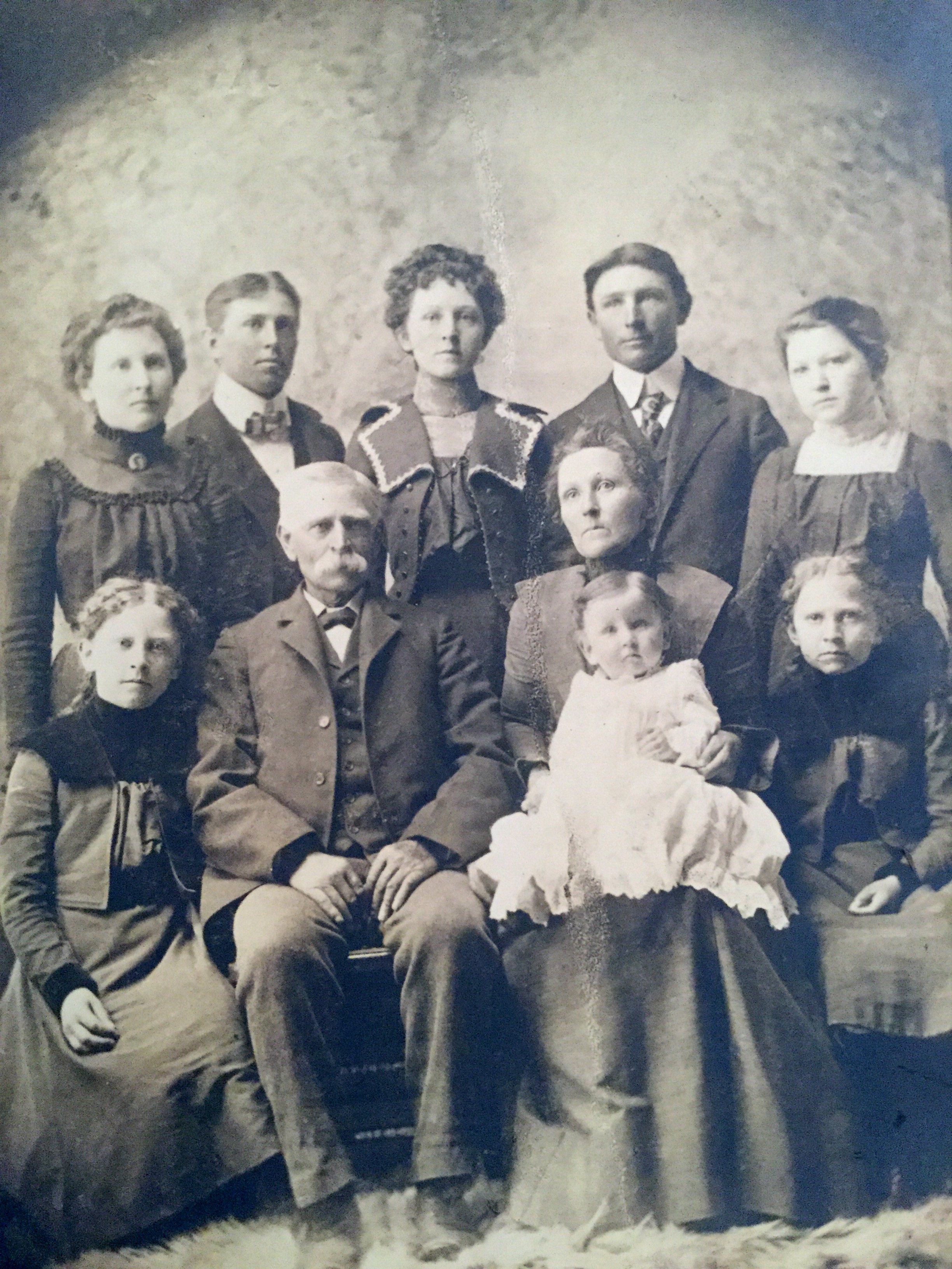 The John O. Gibby and Laura H. Taylor Gibby Family.  Back row, l to r:  Olive May Gibby (August 25, 1881-December 2, 1966), Thomas William Gibby (February 18, 1879-July 28, 1937), Lottie Jane Gibby (August 29, 1884-August 7, 1979), George Franklin Gibby (February 12, 1878-May 23, 1965) and Eva Gibby (July 20, 1886-December 18, 1979).
Second row, l to r:  Gladys Marie Gibby (October 7, 1888-February 26, 1977),  John Owens Gibby (April 29, 1841-April 2, 1926), Laura Henrietta Taylor Gibby (February 18, 1859-November 21, 1943) holding Murrell Earnest Gibby (March 25, 1900-May 5, 1961), and Lillian Gibby (July 17, 1890-October 18, 1987).  