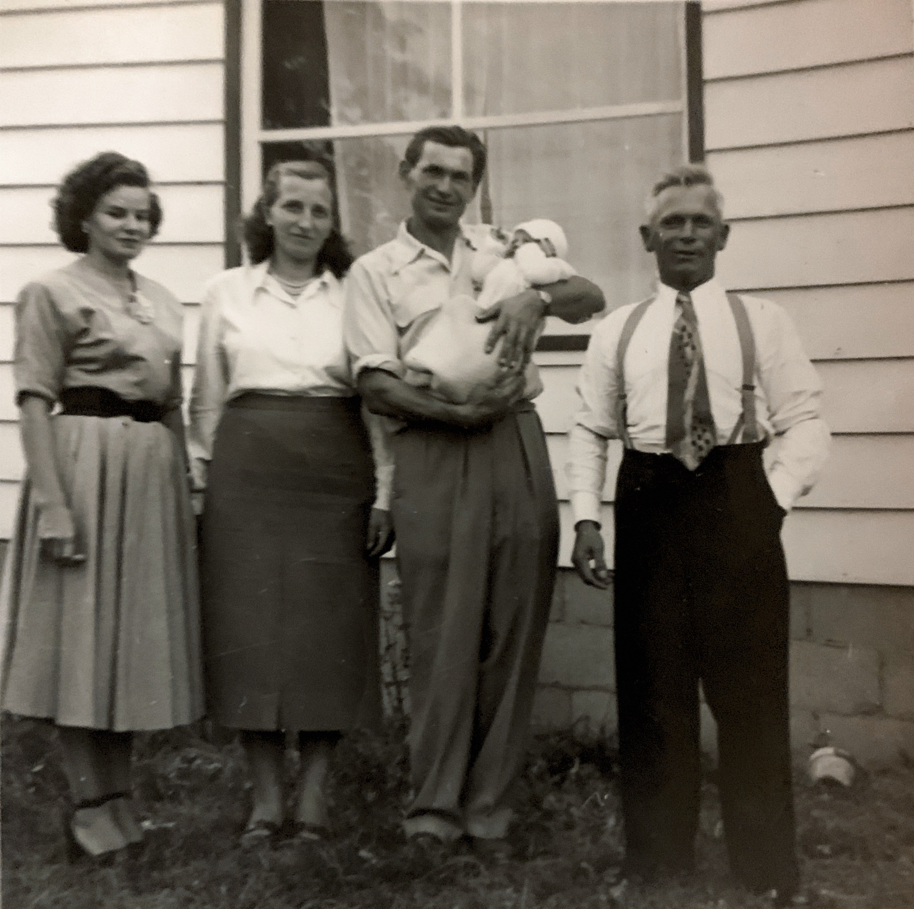 Zdzislaw in 1954 being held by his godfather Alois Orlinta, Dziadek and two ladies Zdzislaw doesn’t know